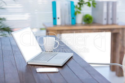 Business desk with laptop and smartphone