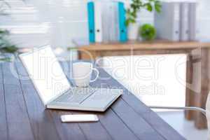 Business desk with laptop and smartphone