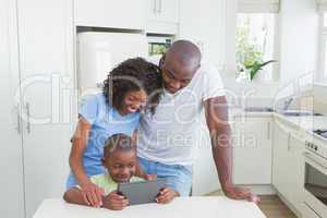 Happy smiling family using digital tablet
