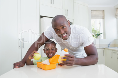 Portrait of a father working with his son