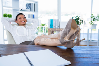 Businesswoman relaxing in a swivel chair