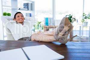 Businesswoman relaxing in a swivel chair