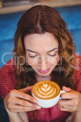 Casual brunette drinking coffee