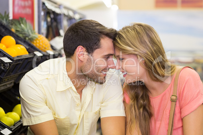 Smiling bright couple buying products