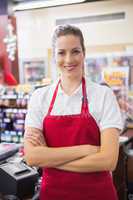 Happy pretty woman looking at camera with arms crossed