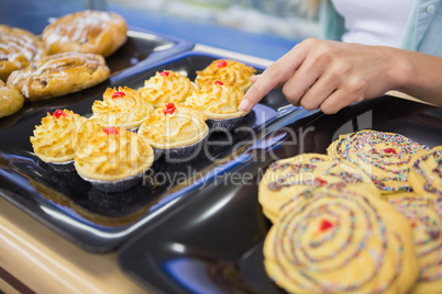 A baker presenting a new plates with pastries