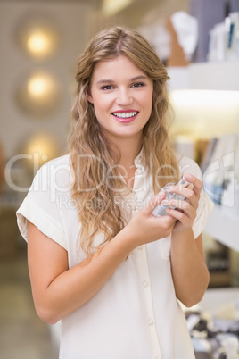 A pretty blonde woman in a perfumery
