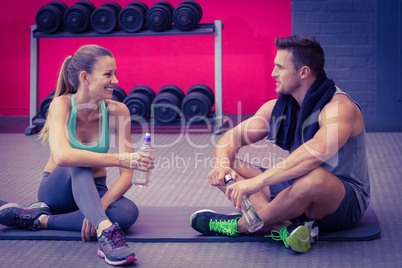 Sitting muscular couple talking together