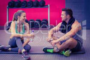 Sitting muscular couple talking together