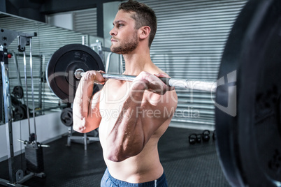 Muscular man lifting a barbell