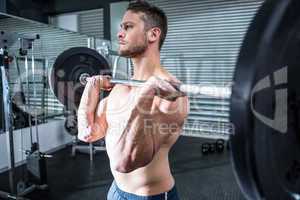 Muscular man lifting a barbell