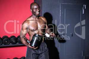 Young Bodybuilder filling his Bottle