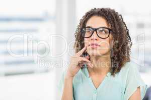 Young businessman looking away in the office