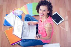 Young creative businesswoman holding a smartphone