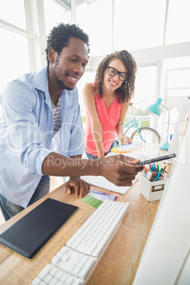 Two creative business colleagues working on the computer