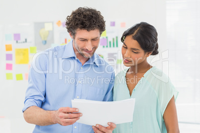 Casual business partners looking at files