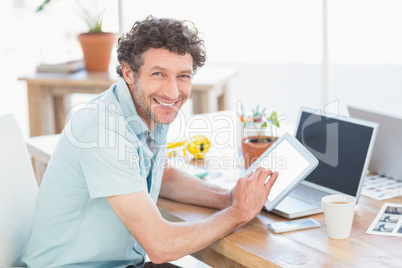 Casual designer using graphics tablet and laptop