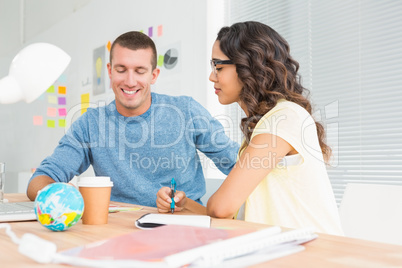 Smiling man speaking to his colleague