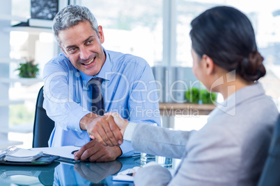 Happy business people shaking hands