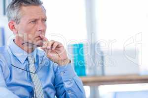 Thoughtful businessman looking away