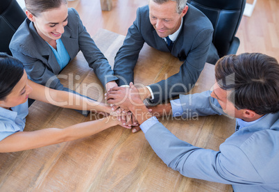 Business people joining hands in a circle