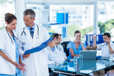 Doctors looking together at clipboard