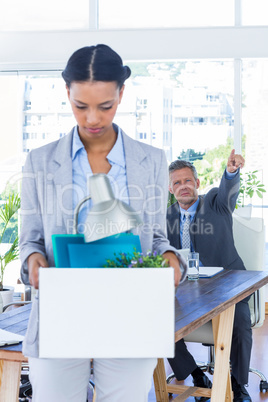 A fired businesswoman holding box