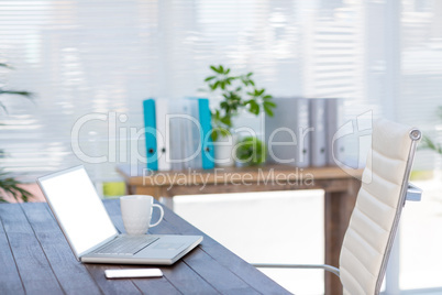 Business desk with laptop and smartphone