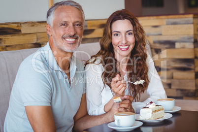 Casual couple having coffee and cake together Casual couple having coffee and cake together