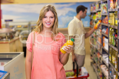 Portrait of a pretty smiling blonde woman buying product