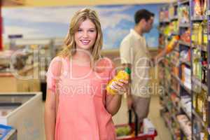 Portrait of a pretty smiling blonde woman buying product