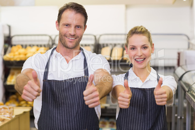 Portrait of a smiling bakers with thumb up