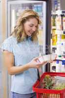 Smiling woman looking at a yogurt on her hands