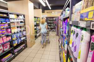 A woman walking in aisle with her trolley