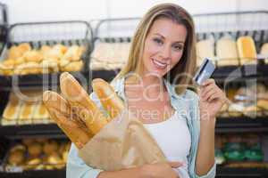 A woman buying bread in the pastries shelf