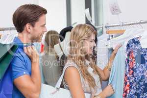 Happy couple choosing new clothes