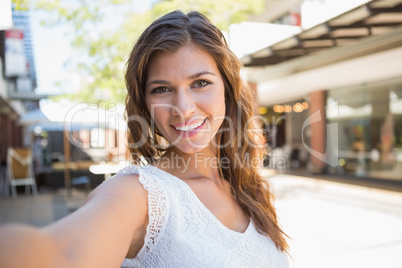 Portrait of smiling woman holding camera