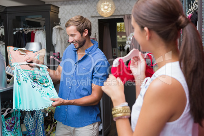 Young happy smiling couple looking at clothes