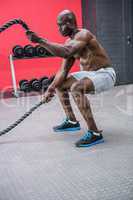 Young Bodybuilder working with ropes