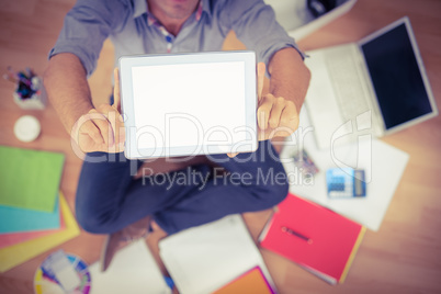 Young creative businessman showing his tablet
