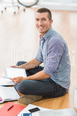 Young creative businessman working on tablet