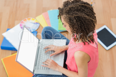 Young creative businesswoman working on laptop