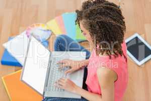 Young creative businesswoman working on laptop