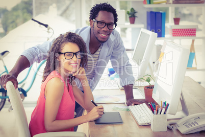 Two creative business colleagues looking at the camera