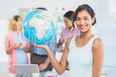 Casual woman holding a globe