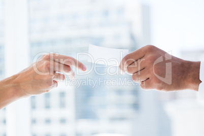 Hands giving small paper sheet to another one