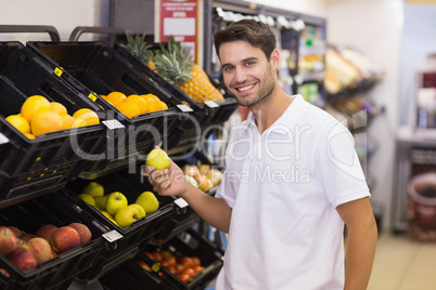 Portrait of a handsome man buying a fruits