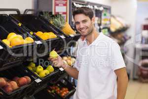 Portrait of a handsome man buying a fruits