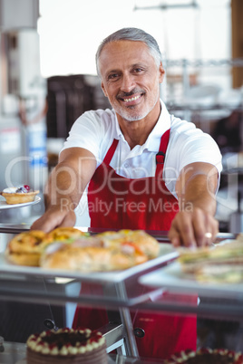 Barista smiling at camera behind counter