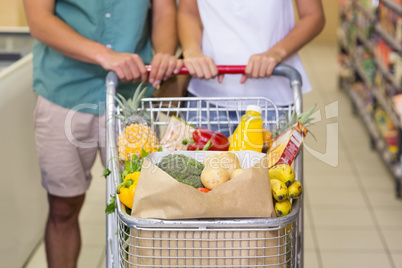 Bright couple buying food products